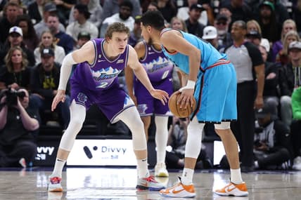 Mar 27, 2023; Salt Lake City, Utah, USA; Utah Jazz forward Lauri Markkanen (23) defends Phoenix Suns guard Devin Booker (1) in the second quarter at Vivint Arena. Mandatory Credit: Rob Gray-USA TODAY Sports