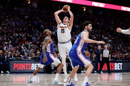 Mar 27, 2023; Denver, Colorado, USA; Denver Nuggets center Nikola Jokic (15) attempts a shot against Philadelphia 76ers forward P.J. Tucker (17) as forward Georges Niang (20) defends in the second quarter at Ball Arena. Mandatory Credit: Isaiah J. Downing-USA TODAY Sports