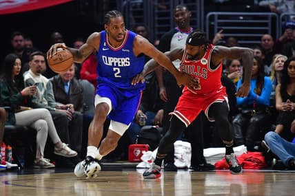 Mar 27, 2023; Los Angeles, California, USA; Los Angeles Clippers forward Kawhi Leonard (2) moves the ball against Chicago Bulls guard Patrick Beverley (21) during the first half at Crypto.com Arena. Mandatory Credit: Gary A. Vasquez-USA TODAY Sports