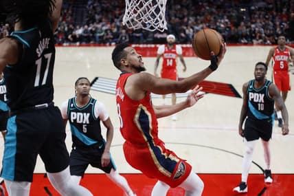 Mar 27, 2023; Portland, Oregon, USA; New Orleans Pelicans shooting guard CJ McCollum (3, right) shoots the ball past Portland Trail Blazers shooting guard Shaedon Sharpe (17) during the second half at Moda Center. Mandatory Credit: Soobum Im-USA TODAY Sports