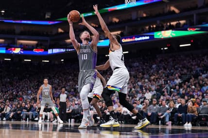 Mar 27, 2023; Sacramento, California, USA; Sacramento Kings forward Domantas Sabonis (10) shoots the ball next to Minnesota Timberwolves center Rudy Gobert (27) in the fourth quarter at the Golden 1 Center. Mandatory Credit: Cary Edmondson-USA TODAY Sports