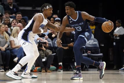 Mar 28, 2023; Memphis, Tennessee, USA; Memphis Grizzlies forward Jaren Jackson Jr. (13) dribbles to the basket as Orlando Magic center Wendell Carter Jr. (34) defends during the first half at FedExForum. Mandatory Credit: Petre Thomas-USA TODAY Sports