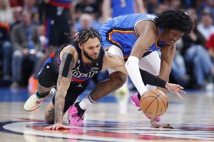Mar 29, 2023; Oklahoma City, Oklahoma, USA;  Detroit Pistons forward Isaiah Livers (12) and Oklahoma City Thunder forward Jalen Williams (8) drive for a loose ball during the second quarter at Paycom Center. Mandatory Credit: Alonzo Adams-USA TODAY Sports