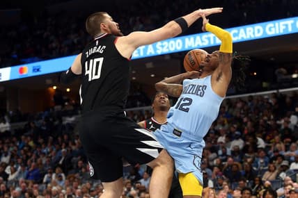Mar 29, 2023; Memphis, Tennessee, USA; Memphis Grizzlies guard Ja Morant (12) drives to the basket as Los Angeles Clippers center Ivica Zubac (40) defends during the first half at FedExForum. Mandatory Credit: Petre Thomas-USA TODAY Sports