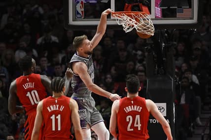 Mar 29, 2023; Portland, Oregon, USA; Sacramento Kings forward Domantas Sabonis (10) dunks the basketball during the first half against Portland Trail Blazers forward Nassir Little (10) at Moda Center. Mandatory Credit: Troy Wayrynen-USA TODAY Sports