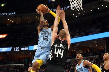 Mar 29, 2023; Memphis, Tennessee, USA; Memphis Grizzlies guard Ja Morant (12) shoots as Los Angeles Clippers center Mason Plumlee (44) defends during the first half at FedExForum. Mandatory Credit: Petre Thomas-USA TODAY Sports