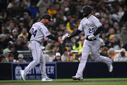 Mar 30, 2023; San Diego, California, USA; Colorado Rockies first baseman C.J. Cron (25) is congratulated by third base coach Warren Schaeffer (34) after hitting a three-run home run during the fifth inning at Petco Park. Mandatory Credit: Orlando Ramirez-USA TODAY Sports
