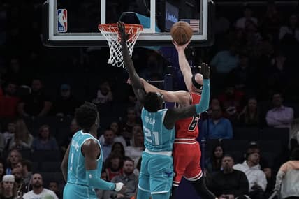 Mar 31, 2023; Charlotte, North Carolina, USA; Chicago Bulls guard Alex Caruso (6) shoots the ball over Charlotte Hornets forward JT Thor (21) in the first quarter at Spectrum Center. Mandatory Credit: David Yeazell-USA TODAY Sports
