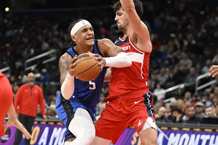 Mar 31, 2023; Washington, District of Columbia, USA; Orlando Magic forward Paolo Banchero (5) dribbles as Washington Wizards forward Deni Avdija (9) defends during the first half at Capital One Arena. Mandatory Credit: Brad Mills-USA TODAY Sports