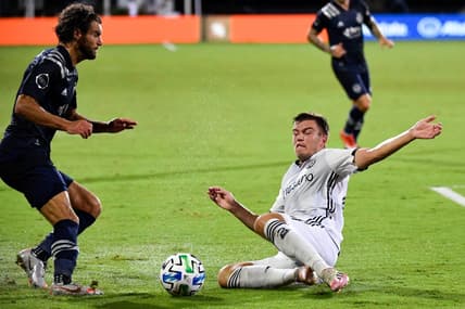 Jul 30, 2020; Orlando, FL, Florida, USA; Sporting Kansas City midfielder Graham Zusi (8) and Philadelphia Union defender Kai Wagner (27) fight for the ball during the first half at ESPN Wide World of Sports Complex. Mandatory Credit: Douglas DeFelice-USA TODAY Sports