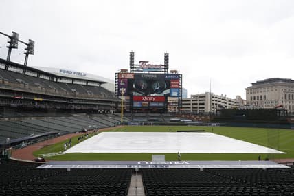 Aug 28, 2020; Detroit, Michigan, USA; The grounds crew prepares to take the tarp off the infield during a weather delay before the game between the Detroit Tigers and the Minnesota Twins on Jackie Robinson Day at Comerica Park. Mandatory Credit: Raj Mehta-USA TODAY Sports