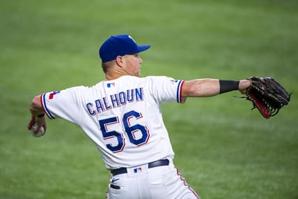 Jul 16, 2022; Arlington, Texas, USA; Texas Rangers left fielder Kole Calhoun (56) throws the ball into the infield during the sixth inning against the Seattle Mariners at Globe Life Field. Mandatory Credit: Jerome Miron-USA TODAY Sports