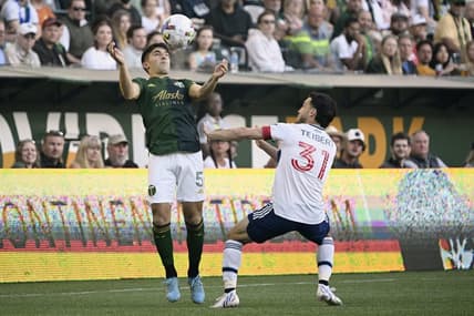 Jul 17, 2022; Portland, Oregon, USA; Vancouver Whitecaps midfielder Russell Teibert (31) defends Portland Timbers defender Claudio Bravo (5) during the first half at Providence Park. The game ended tied 1-1. Mandatory Credit: Troy Wayrynen-USA TODAY Sports