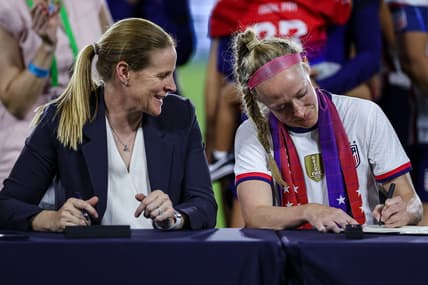 Sep 6, 2022; Washington, District of Columbia, USA; United States Soccer Federation President Cindy Parlow Cone and United States defender Becky Sauerbrunn (4) sign the new Collective Bargaining Agreements after the match between the United States and Nigeria at Audi Field. Mandatory Credit: Scott Taetsch-USA TODAY Sports