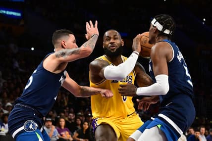 Oct 12, 2022; Los Angeles, California, USA;  Los Angeles Lakers forward LeBron James (6) drives through Minnesota Timberwolves Jaden McDaniels (3) and Minnesota Timberwolves guard Austin Rivers (25) during the third quarter at Crypto.com Arena. Mandatory Credit: Richard Mackson-USA TODAY Sports