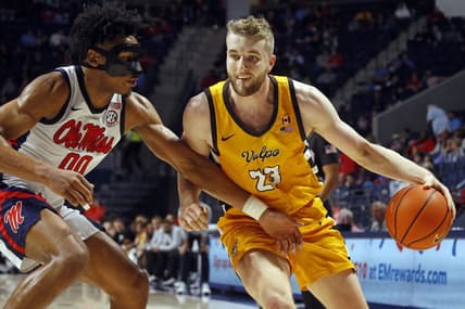 Dec 10, 2022; Oxford, Mississippi, USA; Valparaiso Beacons forward Ben Krikke (23) drives to the basket as Mississippi Rebels forward Jayveous McKinnis (0) defends during the first half at The Sandy and John Black Pavilion at Ole Miss. Mandatory Credit: Petre Thomas-USA TODAY Sports
