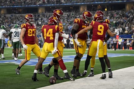 Jan 2, 2023; Arlington, Texas, USA; USC Trojans wide receiver Michael Jackson III (9) and offensive lineman Courtland Ford (74) and running back Raleek Brown (14) and tight end Lake McRee (87) celebrate after Jackson scores a touchdown against the Tulane Green Wave during the first half in the 2023 Cotton Bowl at AT&T Stadium. Mandatory Credit: Jerome Miron-USA TODAY Sports