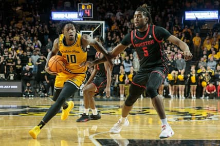 Jan 25, 2023; Wichita, Kansas, USA; Wichita State Shockers guard Jaykwon Walton (10) drives around Houston Cougars forward Ja'Vier Francis (5) during the second half at Charles Koch Arena. Mandatory Credit: William Purnell-USA TODAY Sports