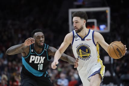 Feb 8, 2023; Portland, Oregon, USA; Golden State Warriors shooting guard Klay Thompson (11) dribbles the ball as Portland Trail Blazers small forward Nassir Little (10)  defends during the second half at Moda Center. Mandatory Credit: Soobum Im-USA TODAY Sports