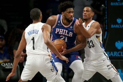 Feb 11, 2023; Brooklyn, New York, USA; Philadelphia 76ers center Joel Embiid (21) drives to the basket against Brooklyn Nets forward Mikal Bridges (1) and center Nic Claxton (33) during the third quarter at Barclays Center. Mandatory Credit: Brad Penner-USA TODAY Sports