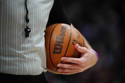 Feb 15, 2023; Denver, Colorado, USA; A detailed view of the game basketball held by referee Brett Nansel (44) during the second quarter between the Dallas Mavericks against the Denver Nuggets at Ball Arena. Mandatory Credit: Ron Chenoy-USA TODAY Sports