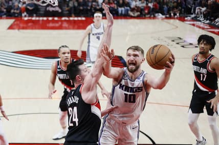 Mar 31, 2023; Portland, Oregon, USA; Sacramento Kings power forward Domantas Sabonis (10) shoots the ball against Portland Trail Blazers power forward Drew Eubanks (24) during the first half at Moda Center. Mandatory Credit: Soobum Im-USA TODAY Sports