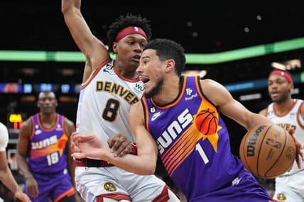 Mar 31, 2023; Phoenix, Arizona, USA; Phoenix Suns guard Devin Booker (1) dribbles against Denver Nuggets forward Peyton Watson (8) during the first half at Footprint Center. Mandatory Credit: Joe Camporeale-USA TODAY Sports
