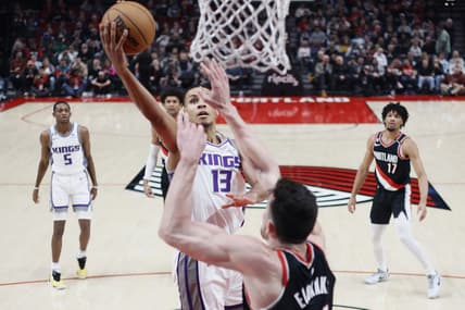 Mar 31, 2023; Portland, Oregon, USA; Sacramento Kings small forward Keegan Murray (13) shoots the ball as Portland Trail Blazers power forward Drew Eubanks (24)  defends during the first half at Moda Center. Mandatory Credit: Soobum Im-USA TODAY Sports