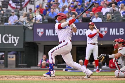 Apr 1, 2023; Arlington, Texas, USA; Texas Rangers catcher Mitch Garver (18) hits a three run home run against the Philadelphia Phillies during the fifth inning at Globe Life Field. Mandatory Credit: Jerome Miron-USA TODAY Sports