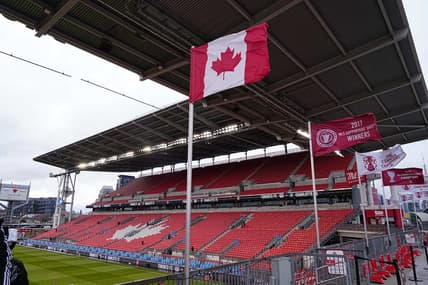 Apr 1, 2023; Toronto, Ontario, CAN;  The Canadian flag and championship banners fly in the stiff wind at BMO Field before a match between Charlotte FC and Toronto FC Mandatory Credit: John E. Sokolowski-USA TODAY Sports