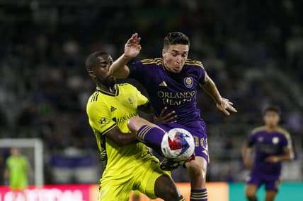 Apr 1, 2023; Orlando, Florida, USA; Orlando City SC midfielder Mauricio Pereyra (10) traps the ball in front of Nashville SC defender Shaq Moore (18) during the first half at Exploria Stadium. Mandatory Credit: Morgan Tencza-USA TODAY Sports