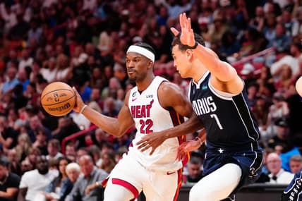 Apr 1, 2023; Miami, Florida, USA; Miami Heat forward Jimmy Butler (22) throws a pass against Dallas Mavericks center Dwight Powell (7) during the second quarter at Miami-Dade Arena. Mandatory Credit: Rich Storry-USA TODAY Sports
