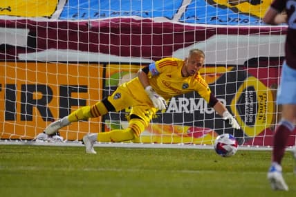 Apr 1, 2023; Commerce City, Colorado, USA; Colorado Rapids goalkeeper William Yarbrough (22) reaches for the ball during the first half at Dick's Sporting Goods Park. Mandatory Credit: Ron Chenoy-USA TODAY Sports