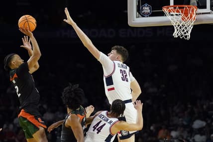 Apr 1, 2023; Houston, TX, USA; Miami (Fl) Hurricanes guard Isaiah Wong (2) shoots the ball as Connecticut Huskies center Donovan Clingan (32) defends during the second half in the semifinals of the Final Four of the 2023 NCAA Tournament at NRG Stadium. Mandatory Credit: Bob Donnan-USA TODAY Sports