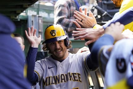 Apr 2, 2023; Chicago, Illinois, USA; Milwaukee Brewers third baseman Brian Anderson (9) is greeted in the dugout after scoring against the Chicago Cubs during the fourth inning at Wrigley Field. Mandatory Credit: David Banks-USA TODAY Sports