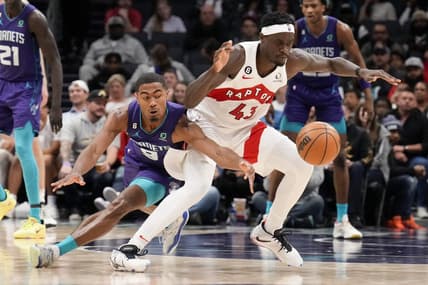 Apr 2, 2023; Charlotte, North Carolina, USA; Charlotte Hornets guard Theo Maledon (9) tries for a steal against Toronto Raptors forward Pascal Siakam (43) during second half at Spectrum Center. Mandatory Credit: Jim Dedmon-USA TODAY Sports