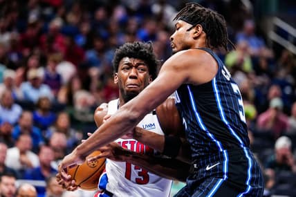 Apr 2, 2023; Orlando, Florida, USA; Detroit Pistons center James Wiseman (13) dribbles the ball past Orlando Magic forward Chuma Okeke (3) during the first quarter at Amway Center. Mandatory Credit: Rich Storry-USA TODAY Sports