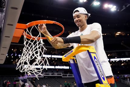 Mar 26, 2023; Kansas City, MO, USA; Miami (Fl) Hurricanes guard Jordan Miller (11) cuts down the net after defeating the Texas Longhorns in an Elite 8 college basketball game in the Midwest Regional of the 2023 NCAA Tournament at T-Mobile Center. Mandatory Credit: Jay Biggerstaff-USA TODAY Sports