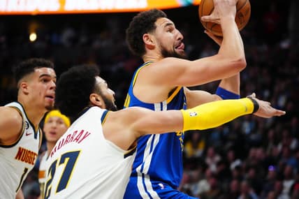 Apr 2, 2023; Denver, Colorado, USA; Golden State Warriors guard Klay Thompson (11) shoots past Denver Nuggets guard Jamal Murray (27) in the second quarter at Ball Arena. Mandatory Credit: Ron Chenoy-USA TODAY Sports