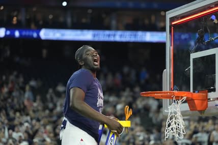 Apr 3, 2023; Houston, TX, USA; Connecticut Huskies forward Adama Sanogo (21) celebrates while cutting down the net after defeating the San Diego State Aztecs in the national championship game of the 2023 NCAA Tournament at NRG Stadium. Mandatory Credit: Bob Donnan-USA TODAY Sports