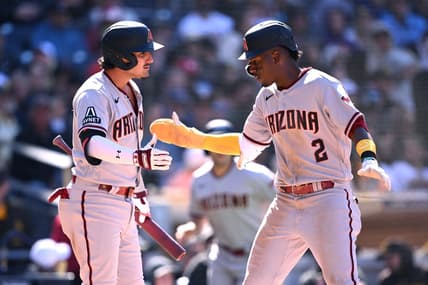 Apr 4, 2023; San Diego, California, USA; Arizona Diamondbacks shortstop Geraldo Perdomo (2) is congratulated by third baseman Josh Rojas (10) after scoring a run during the eighth inning against the San Diego Padres at Petco Park. Mandatory Credit: Orlando Ramirez-USA TODAY Sports