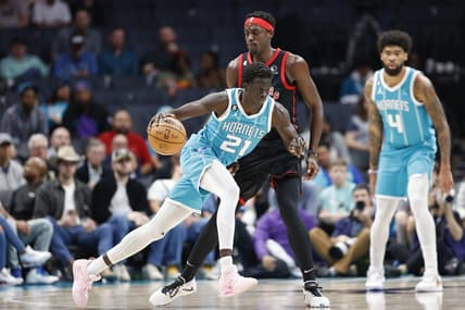 Apr 4, 2023; Charlotte, North Carolina, USA; Charlotte Hornets forward JT Thor (21) drives into Toronto Raptors forward Pascal Siakam (43) as center Nick Richards (4) looks on during the first half at Spectrum Center. Mandatory Credit: Nell Redmond-USA TODAY Sports