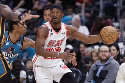 Apr 4, 2023; Detroit, Michigan, USA;  Miami Heat forward Jimmy Butler (22) dribbles defended by Detroit Pistons guard Jaden Ivey (23) in the first half at Little Caesars Arena. Mandatory Credit: Rick Osentoski-USA TODAY Sports