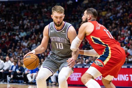 Apr 4, 2023; New Orleans, Louisiana, USA;  Sacramento Kings forward Domantas Sabonis (10) dribbles against New Orleans Pelicans center Jonas Valanciunas (17) during the first half at Smoothie King Center. Mandatory Credit: Stephen Lew-USA TODAY Sports