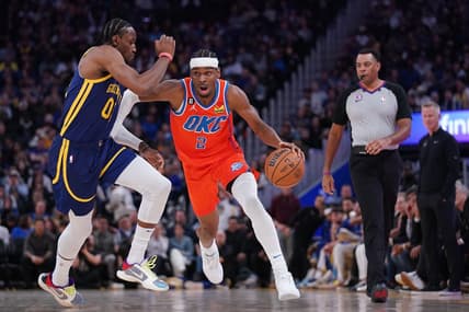 Apr 4, 2023; San Francisco, California, USA; Oklahoma City Thunder guard Shai Gilgeous-Alexander (2) dribbles past Golden State Warriors forward Jonathan Kuminga (00) in the second quarter at the Chase Center. Mandatory Credit: Cary Edmondson-USA TODAY Sports