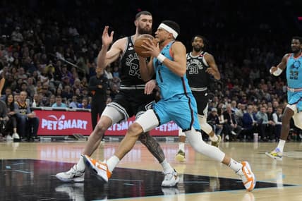 Apr 4, 2023; Phoenix, Arizona, USA; Phoenix Suns guard Devin Booker (1) drives on San Antonio Spurs forward Sandro Mamukelashvili (54) in the first half at Footprint Center. Mandatory Credit: Rick Scuteri-USA TODAY Sports