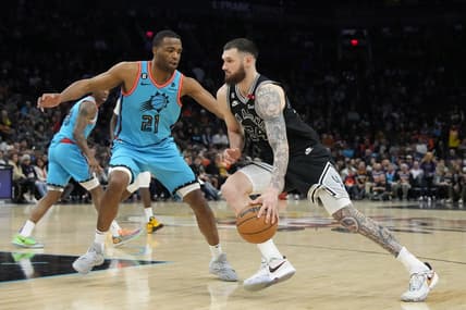 Apr 4, 2023; Phoenix, Arizona, USA; San Antonio Spurs forward Sandro Mamukelashvili (54) drives on Phoenix Suns forward T.J. Warren (21) in the second half at Footprint Center. Mandatory Credit: Rick Scuteri-USA TODAY Sports
