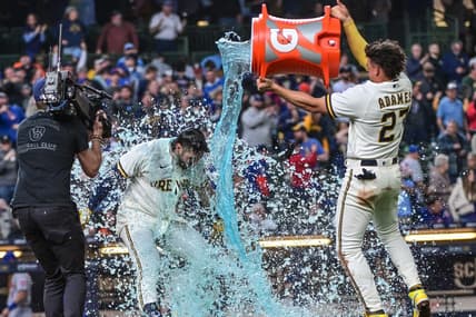 Apr 5, 2023; Milwaukee, Wisconsin, USA; Milwaukee Brewers shortstop Willy Adames (27) dunks left fielder Garrett Mitchell (5) after hitting the game-winning home run in the ninth inning against the New York Mets at American Family Field. Mandatory Credit: Benny Sieu-USA TODAY Sports