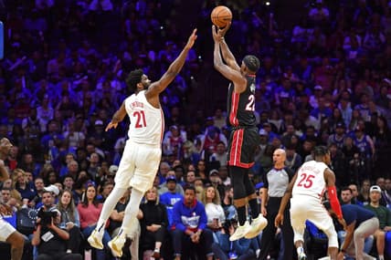 Apr 6, 2023; Philadelphia, Pennsylvania, USA; Miami Heat forward Jimmy Butler (22) shoots a three pointer shot over Philadelphia 76ers center Joel Embiid (21) during the third quarter at Wells Fargo Center. Mandatory Credit: Eric Hartline-USA TODAY Sports