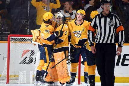 Apr 6, 2023; Nashville, Tennessee, USA; Nashville Predators goaltender Juuse Saros (74) is congratulated by left wing Kiefer Sherwood (44) and defenseman Cal Foote (52) after a shutout win against the Carolina Hurricanes at Bridgestone Arena. Mandatory Credit: Christopher Hanewinckel-USA TODAY Sports